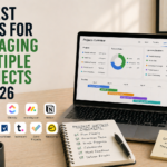 Minimal workspace with laptop showing project dashboard, notebook checklist, and coffee representing tools for managing multiple projects